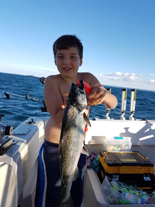 Angler with a big 23-inch fish caught while fishing in ON