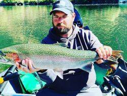 Angler with a large rainbow trout in Grants Pass