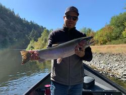 An angler holding a beautiful rainbow trout in Grants Pass
