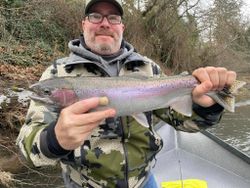 Angler catching a 21-inch rainbow trout in Grants Pass