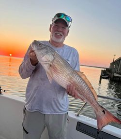 A person fishing for a redfish in Texas City