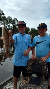 A pair of anglers fishing in FL with a big 21-inch fish