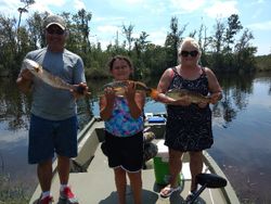 Three anglers posing with their catch in Florida