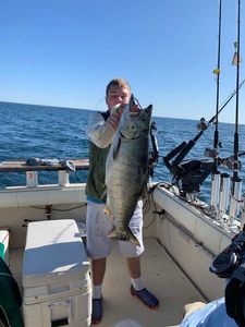 A lone angler reeling in their catch in MI