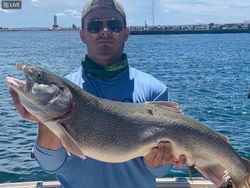 Fisherman reeling in a big fish at Mackinaw City