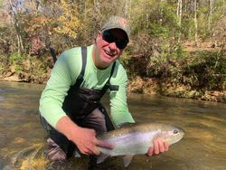 Angler catching a beautiful Rainbow Trout in Cornelia