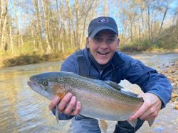 Angler catching a rainbow trout in GA