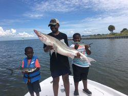 Two fishermen reeling in their catch at Ruskin location