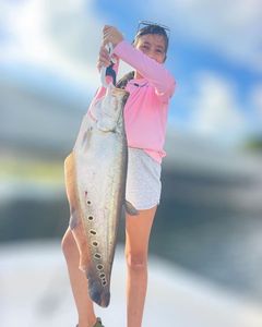 A person fishing with a rod in FL