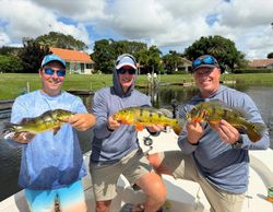 Three people fishing on the water in FL