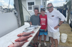 Three anglers holding large fish from Niceville