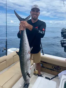 A fisherman holding a king mackerel in Florida