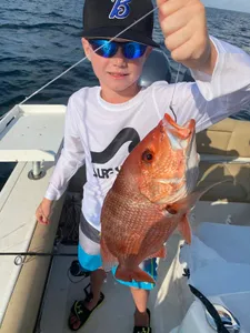 A fisherman in Niceville with a freshly caught fish