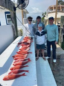 Fresh caught red snapper lined up on fishing boat deck in Niceville FL