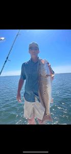 A lone angler fishing at the beautiful Orange Beach