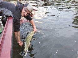 Smiling angler enjoying fishing in Mosinee