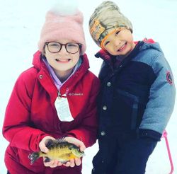 Two people fishing in Mosinee with 1 small fish