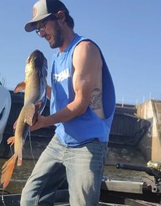 A fisherman holds a 28-inch brown bullhead in WI