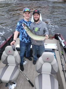 Angler holding a large muskellunge fish in Wisconsin