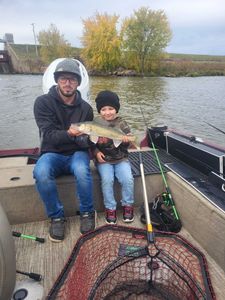Fisherman holding a 16-inch walleye in WI