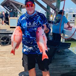 Two anglers holding big fish in Gulf Shores