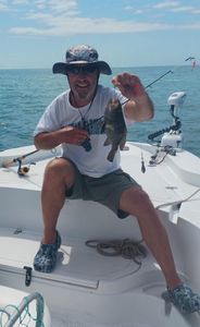 A fisherman holding a sea bass caught in SC