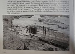 Historic construction of Yuma irrigation weir structure across river with concrete gates and construction equipment