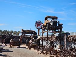 Vintage cars and antique machinery displayed at outdoor attraction in Yuma AZ with Texaco sign