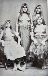 Historical black and white photograph showing four Native American individuals in traditional dress in Yuma Arizona