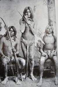 Historical black and white photograph showing three Native American warriors with traditional spears and arrows in Yuma AZ