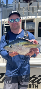Angler holding a king mackerel fish from Falmouth
