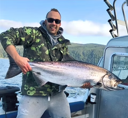 A lone fisherman casting his line in the waters of BC