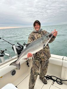 A person fishing for a large Chinook Salmon at 990 Point Breeze Road