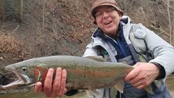 Angler with a large rainbow trout caught in Angola