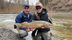 Angler with big rainbow trout in NY