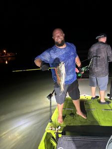 Angler catching an Atlantic Croaker fish in FL