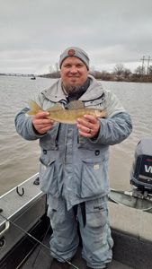 A fisherman holding a 14-inch catch in Wisconsin