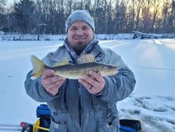 Fisherman holding a fish in WI