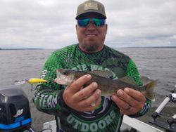 A fisherman holding a 15-inch fish in Wisconsin Rapids