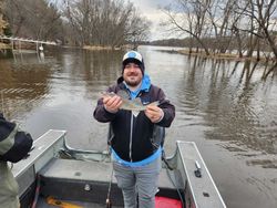 A fisherman with a 12-inch fish in WI
