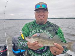 Fisherman holding a walleye fish caught in WI