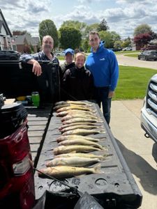 Anglers posing with a large fish in Michigan
