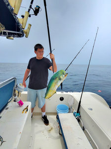 Reeling in a 17-inch Mahi Mahi on a partly cloudy day!
