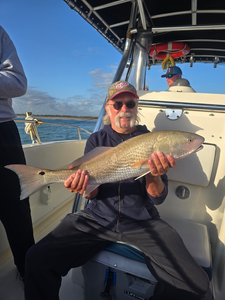 Reeling in a big one on a beautiful day out on the water.