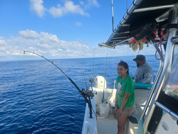 Reeling in a great catch on the open seas.