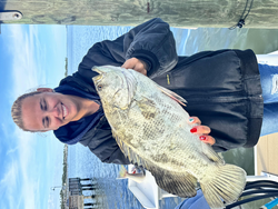 "Successful catch at the indoor fishing facility."