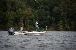 A person fishing near the sign for King George