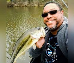 Angler holding spotted bass fish in VA