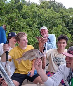 5 people enjoying a fishing trip in St. Petersburg