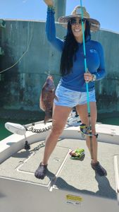 Angler posing with a 14-inch fish in St. Petersburg